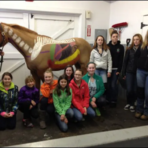 Children in Team Riders 4-H Club posing in front of horse